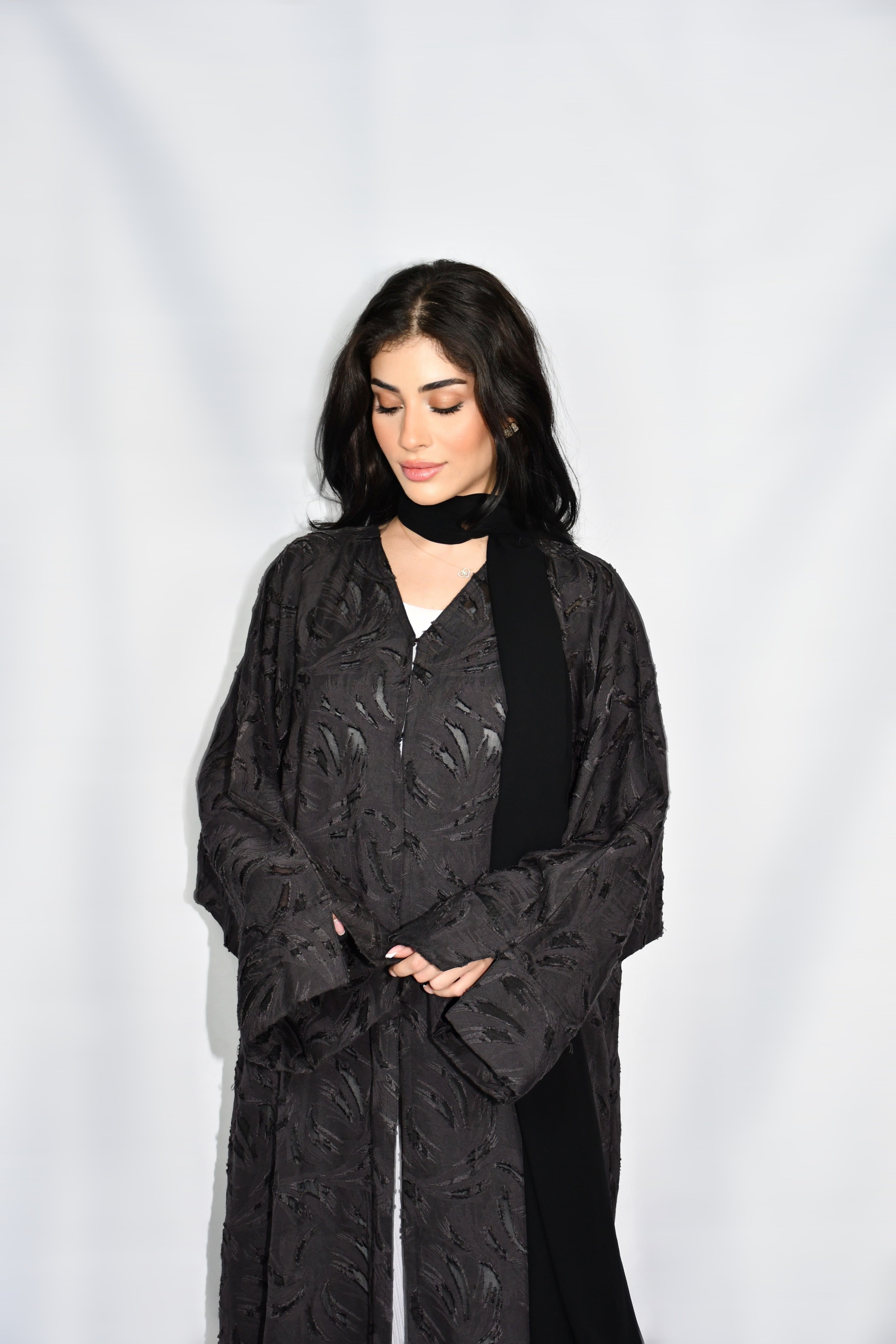 A Rima Atelier open-front abaya in black floral jacquard
